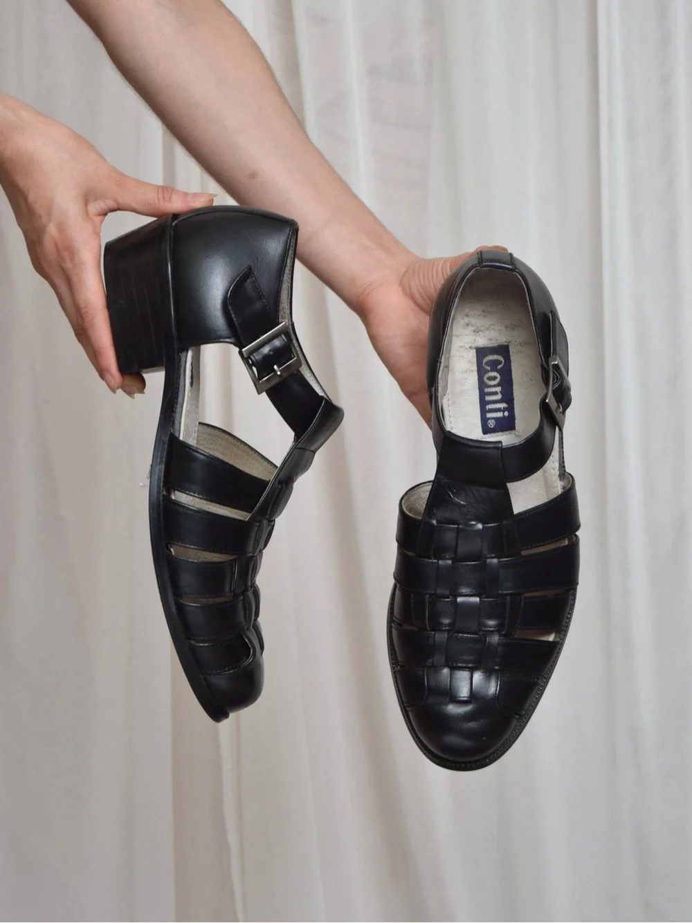 Black leather woven sandals / huaraches with buckle detail.